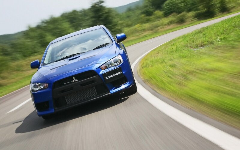 blue mitsubishi car on road