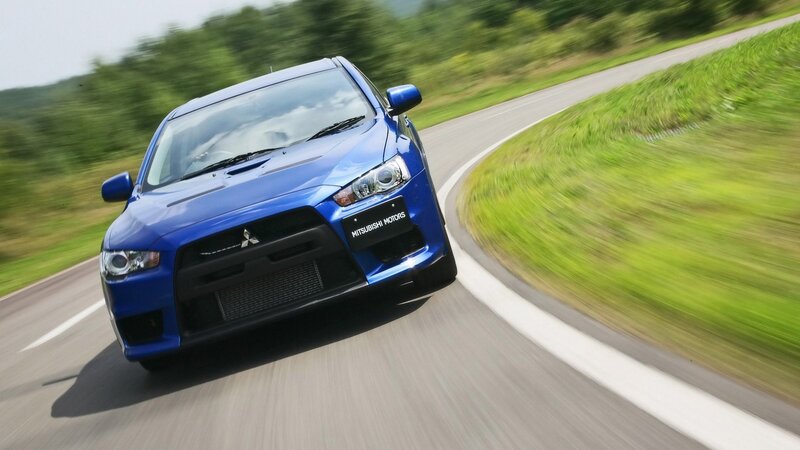 blue mitsubishi car on road