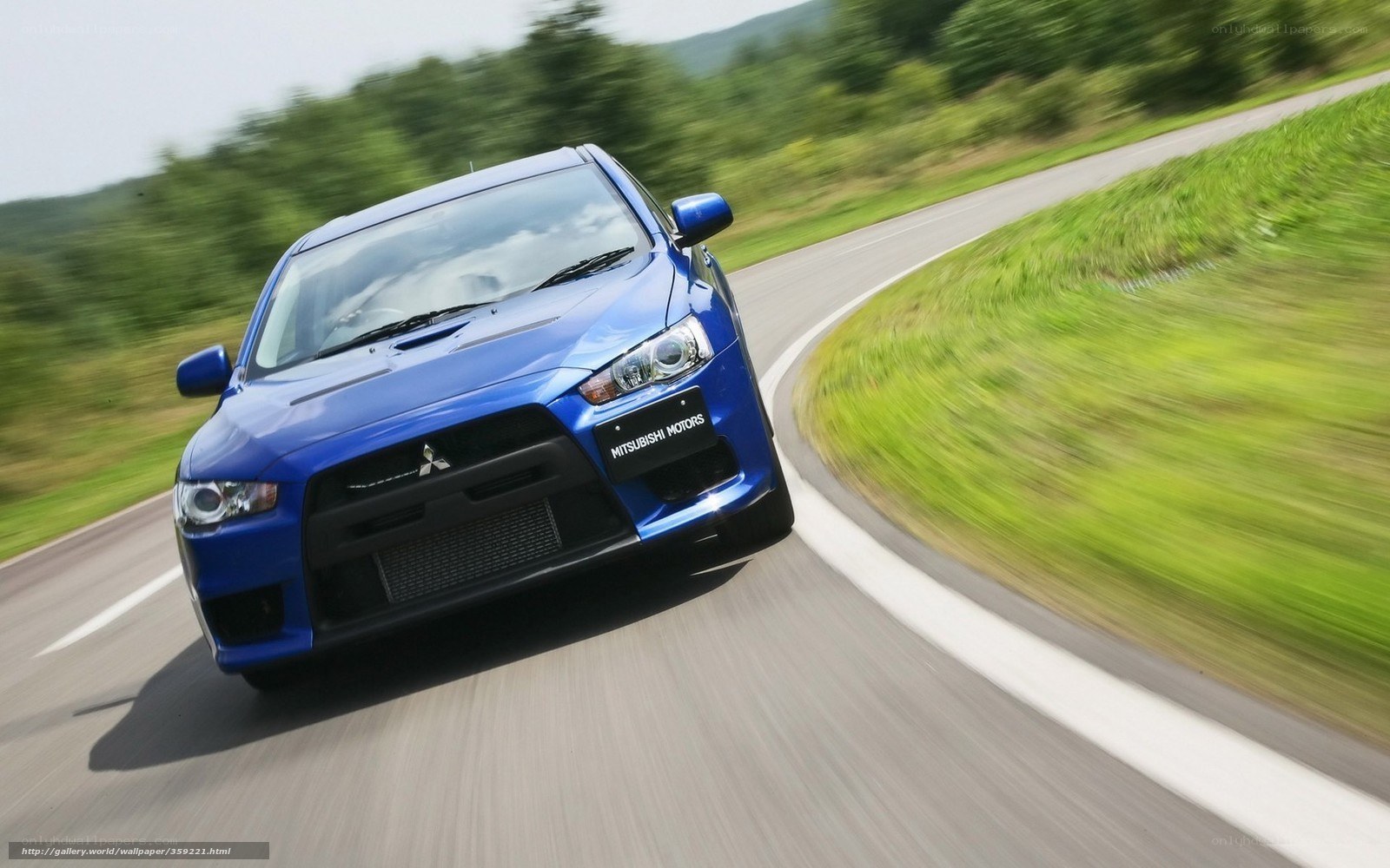 blue mitsubishi car on road