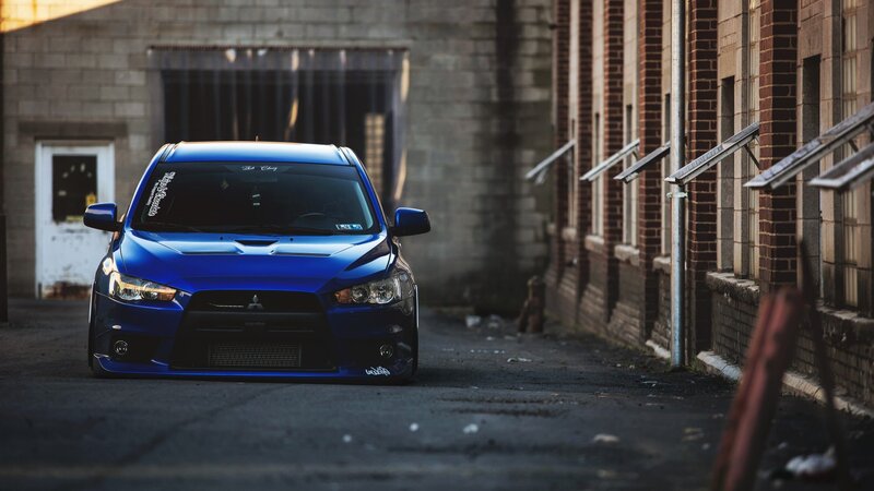 blue mitsubishi in alley