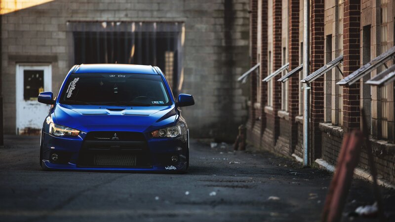 Blue Mitsubishi Lancer — Dramatic, Sunset