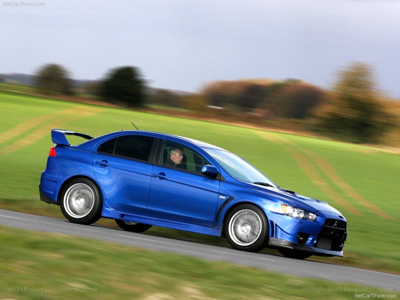blue mitsubishi lancer evolution on road