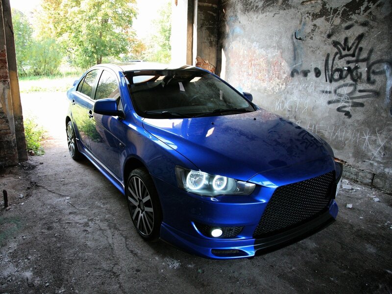 Blue Mitsubishi Lancer in an abandoned building