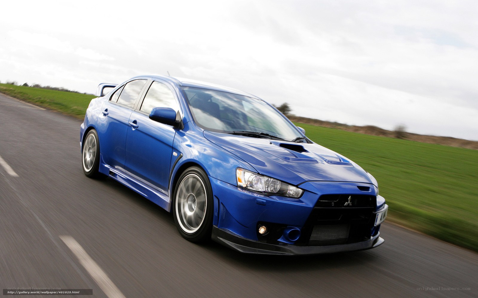 blue mitsubishi lancer in motion