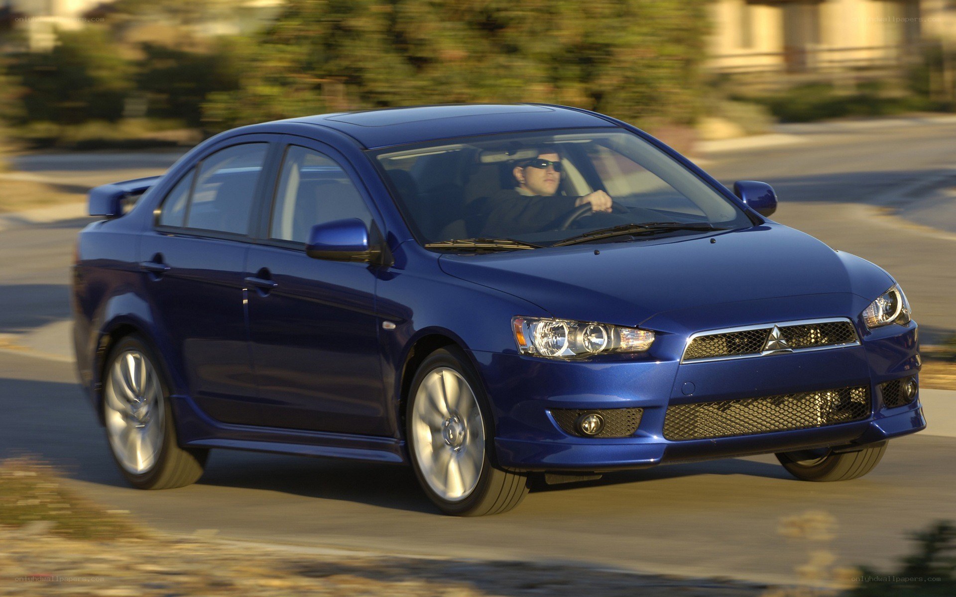 blue mitsubishi lancer in motion