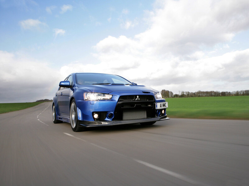 blue mitsubishi lancer in motion