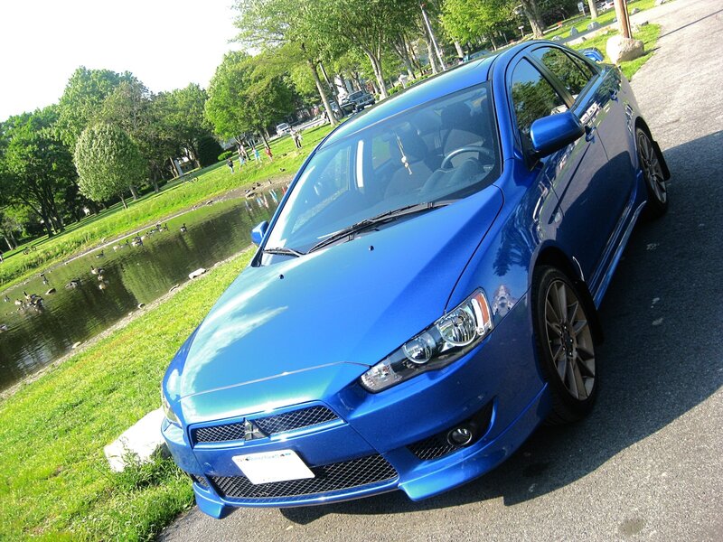 Blue Mitsubishi Lancer — Serene, Afternoon, Photograph, Pond