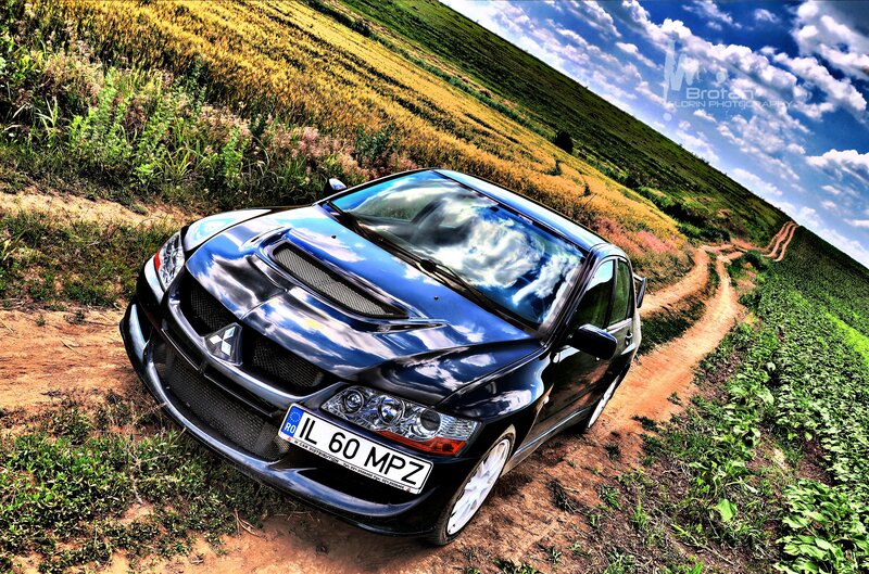 Blue Mitsubishi on a dirt road