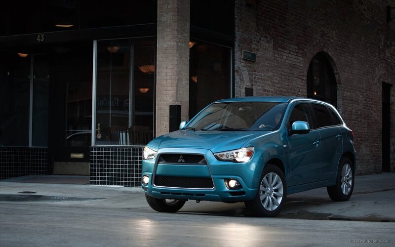 Blue Mitsubishi SUV on city street
