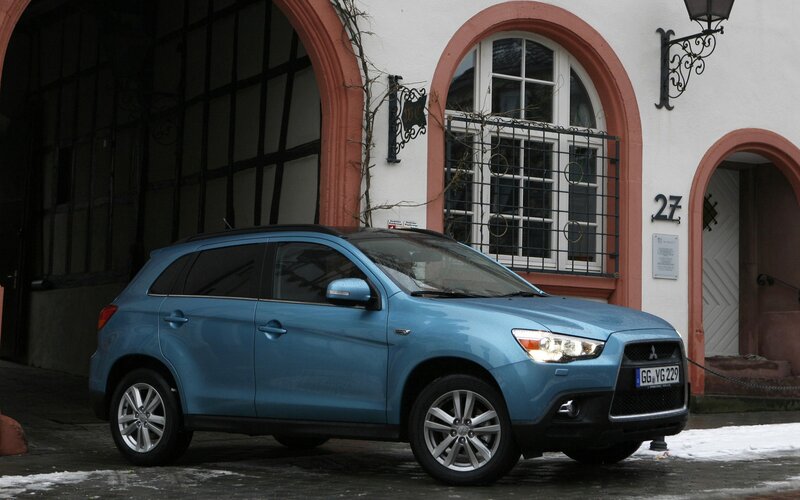 Blue Mitsubishi SUV parked outside