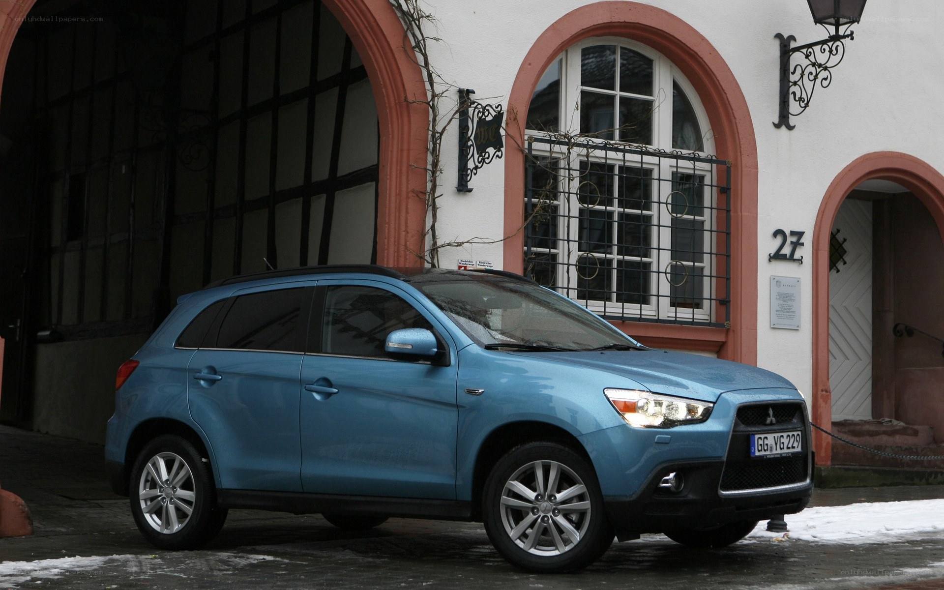 Blue Mitsubishi SUV parked outside