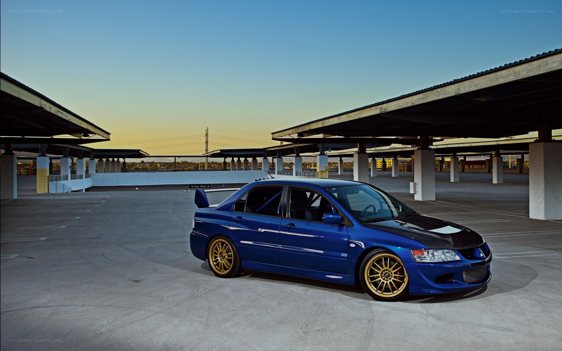 blue modified car in parking garage
