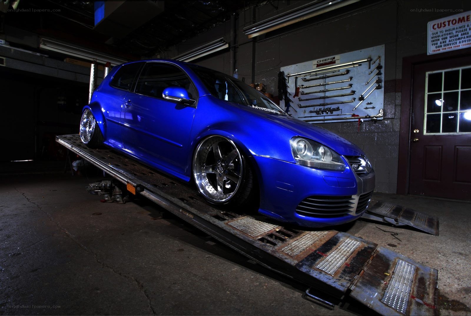 Blue modified car on lift