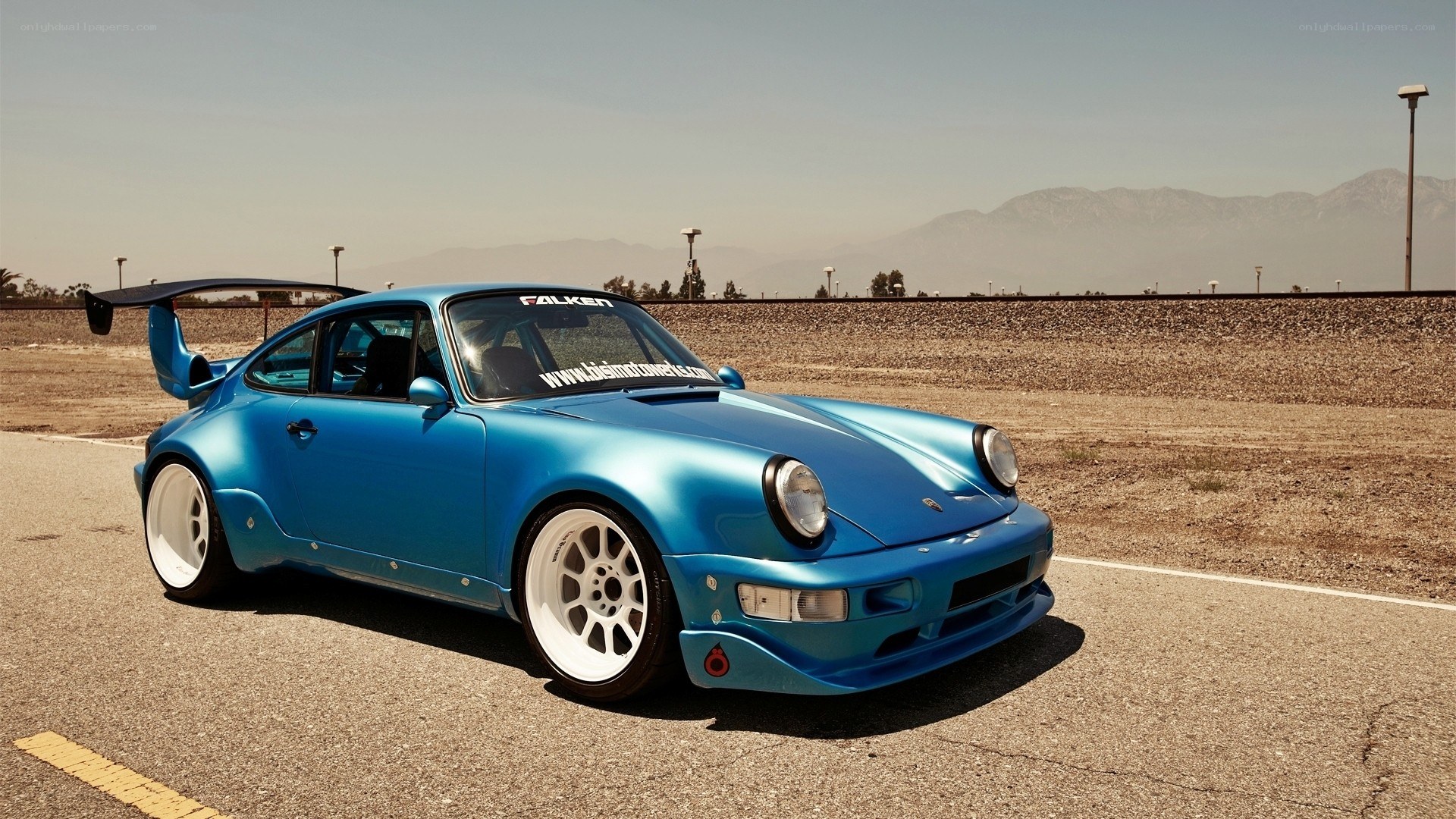 blue modified porsche on track