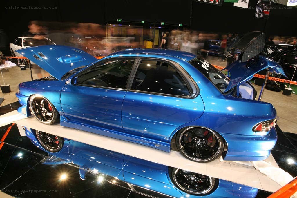 blue modified sedan at car show