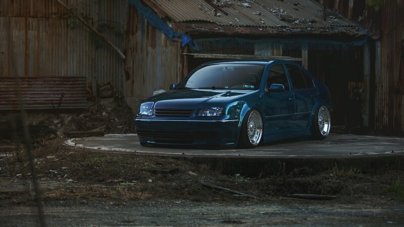 Blue Modified Sedan — Dramatic, Night, Photograph, Rusty Shed