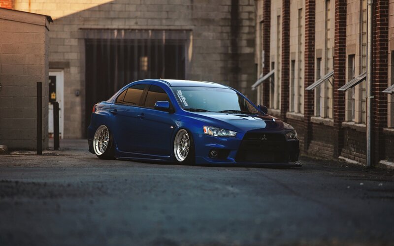 Blue Modified Sedan — Dramatic, Sunset, Photograph, Building