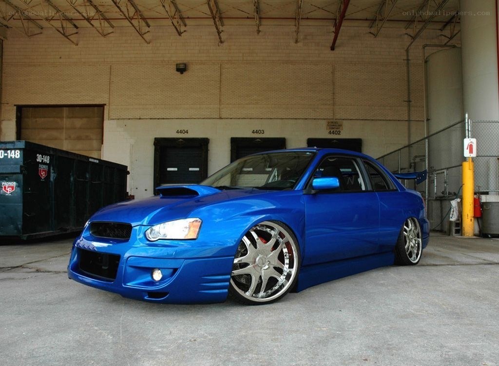 blue modified sedan in garage