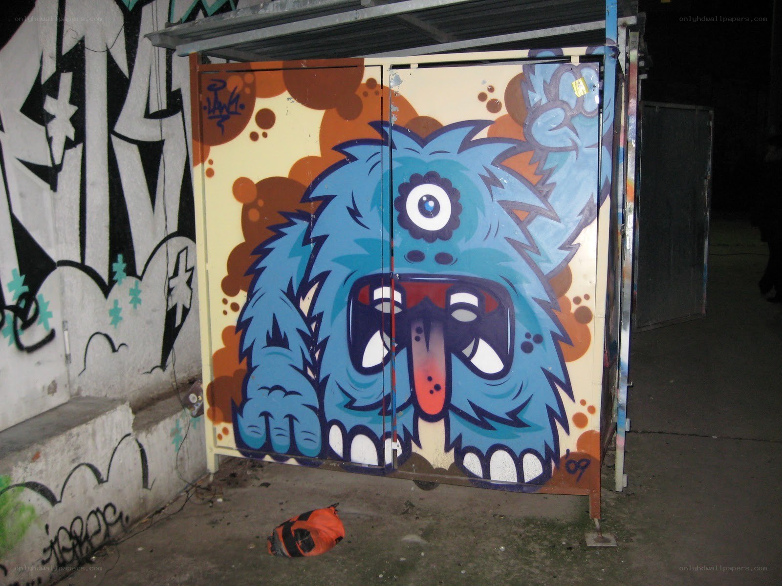 Blue monster graffiti on a cabinet