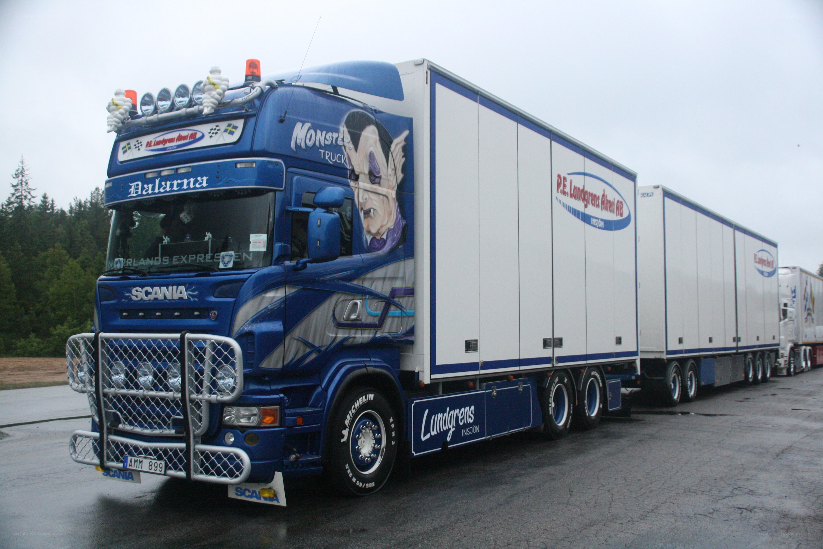 Blue monster truck with trailers