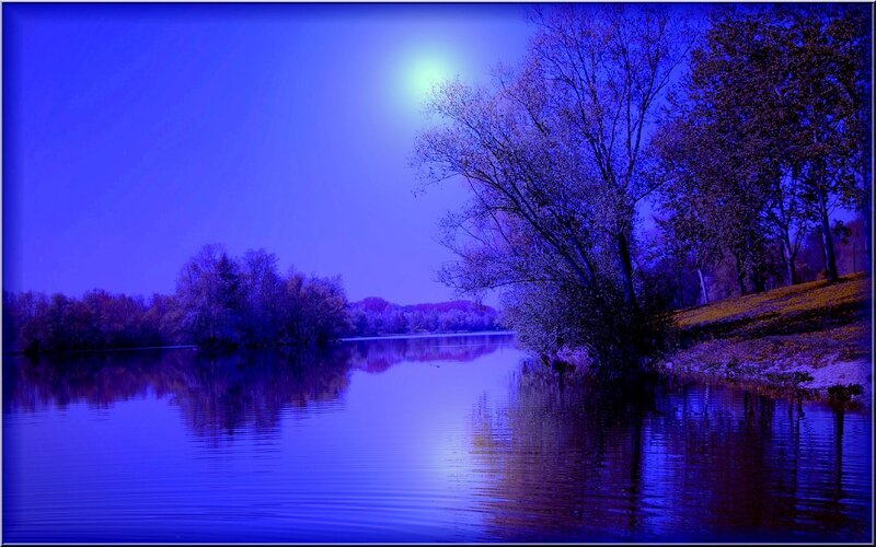 Blue moon over a calm lake
