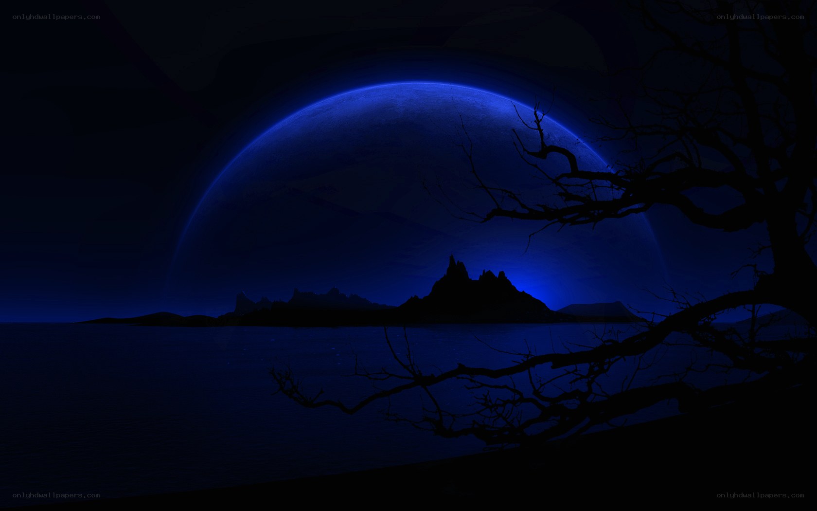 Blue moon over dark landscape