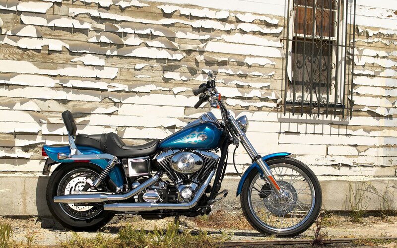 Blue motorcycle against peeling wall