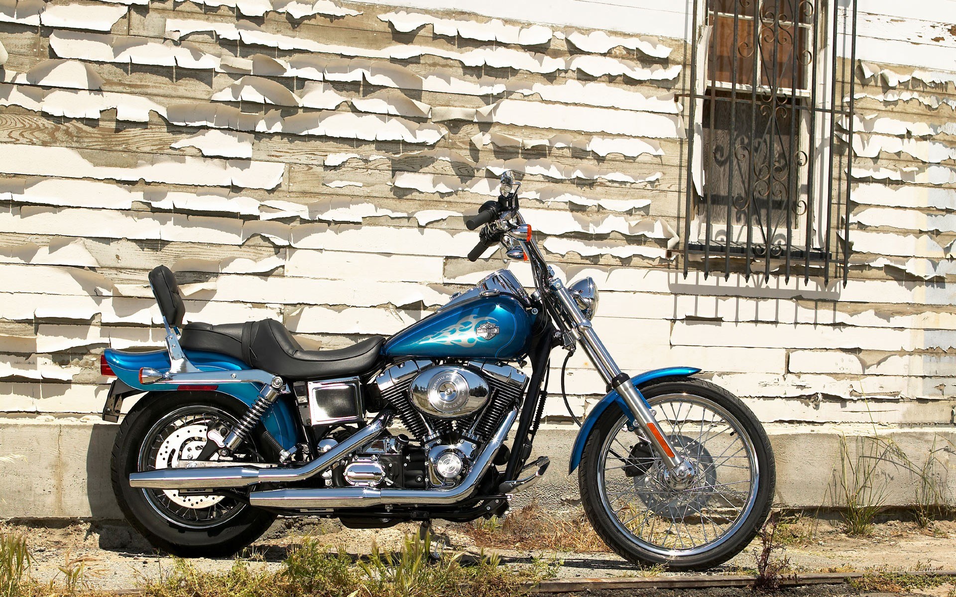 Blue motorcycle against peeling wall