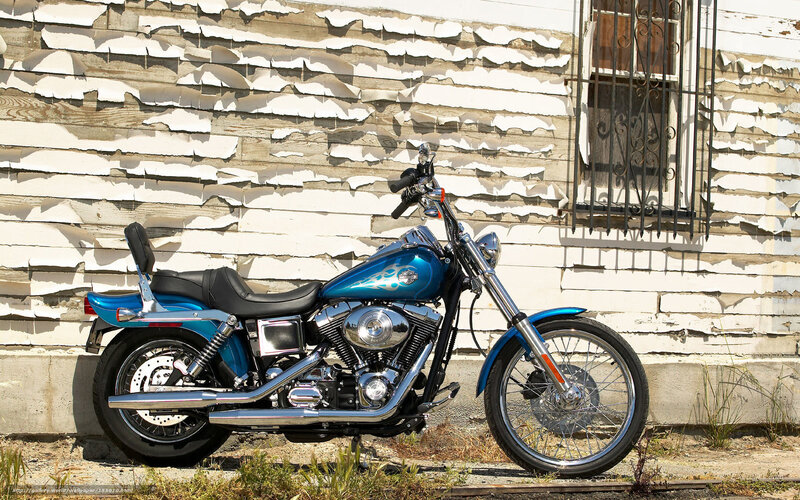 Blue motorcycle against peeling wall