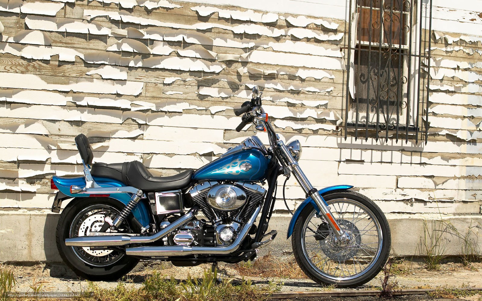 Blue motorcycle against peeling wall