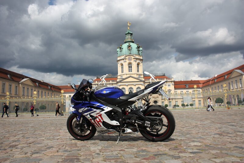 Blue motorcycle in front of palace