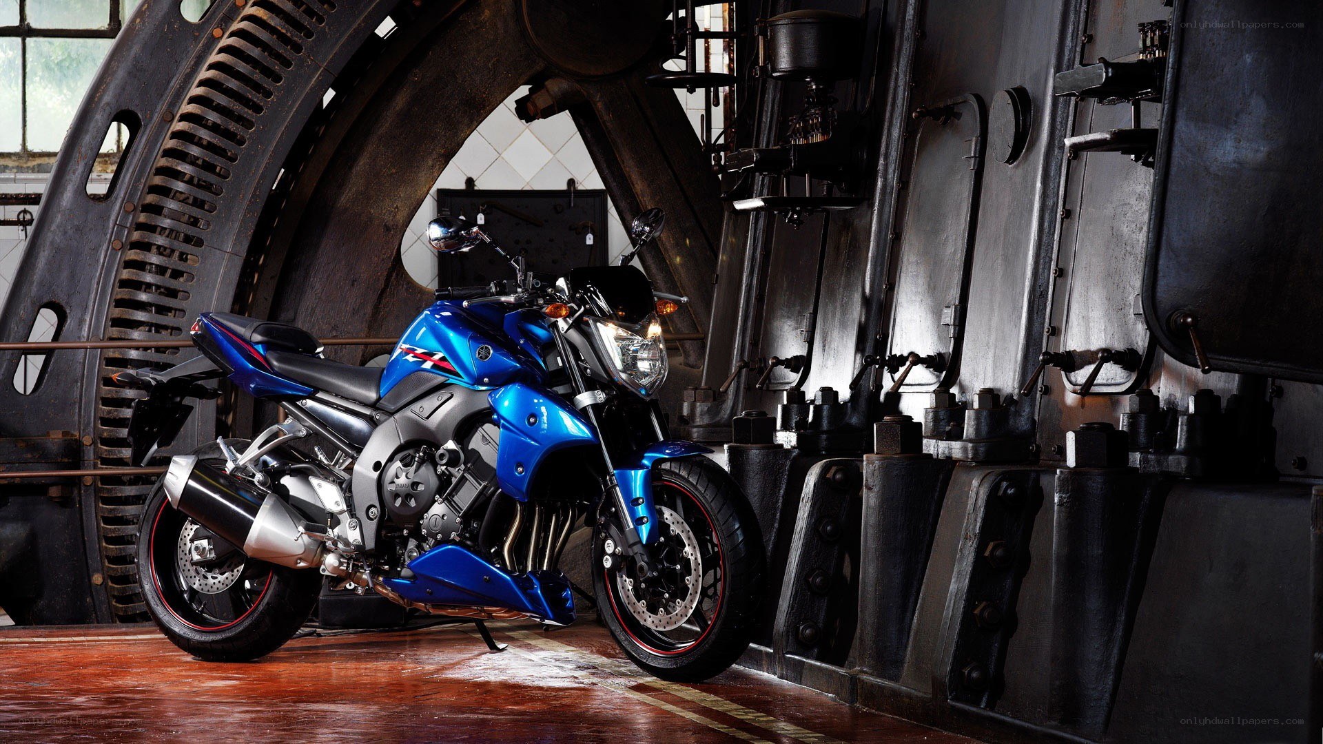 Blue motorcycle in industrial setting