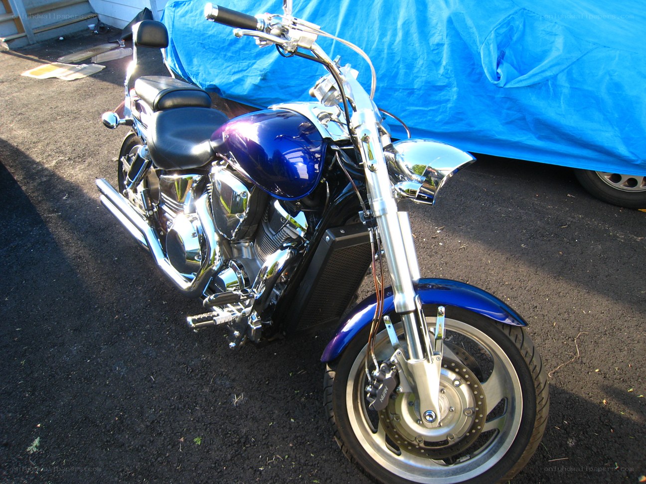 blue motorcycle on asphalt