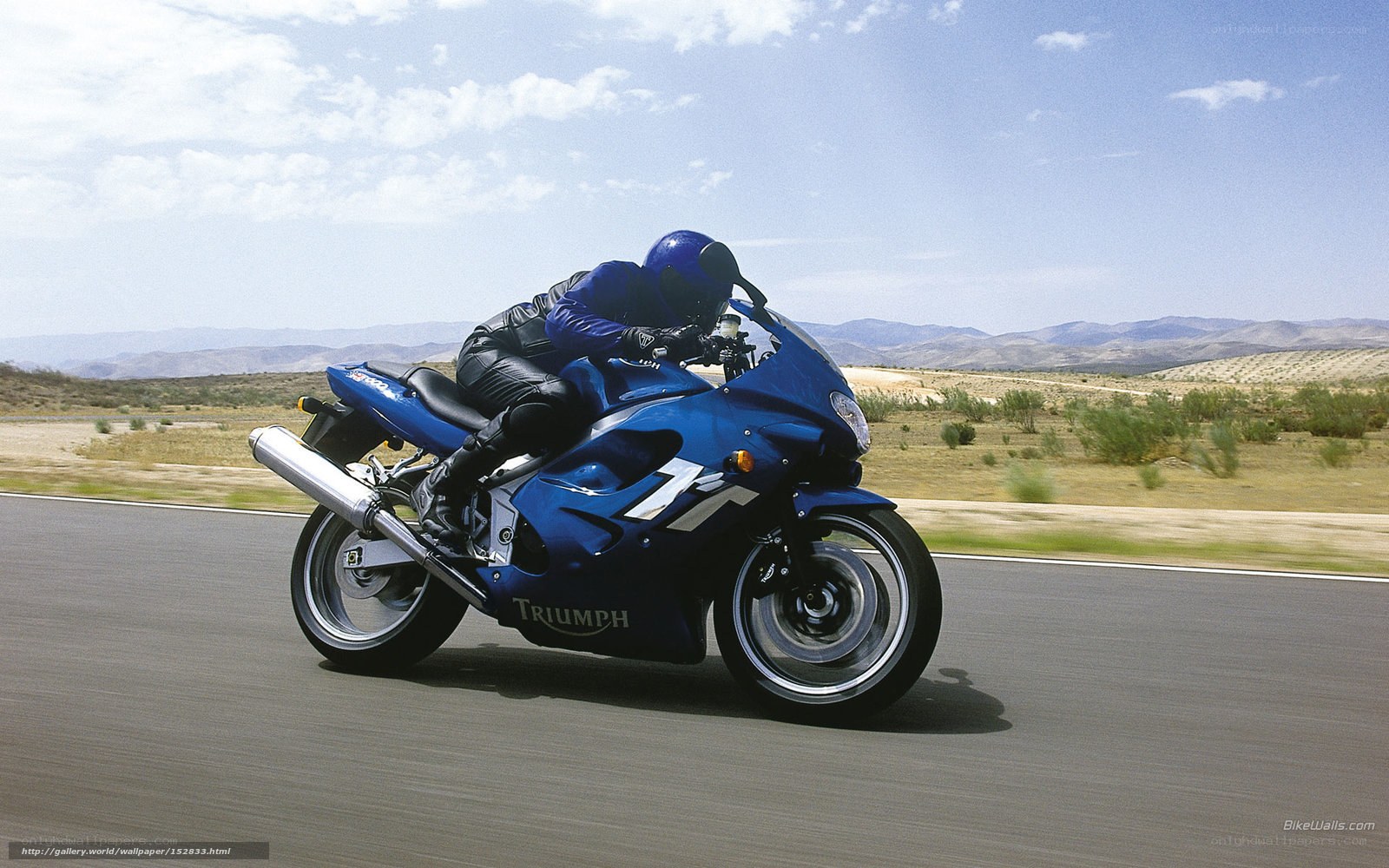 Blue motorcycle on desert road