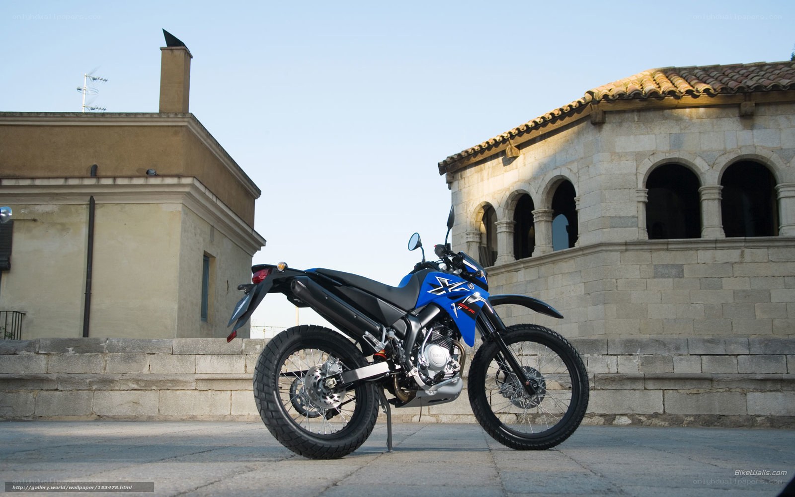 Blue motorcycle on stone pavement
