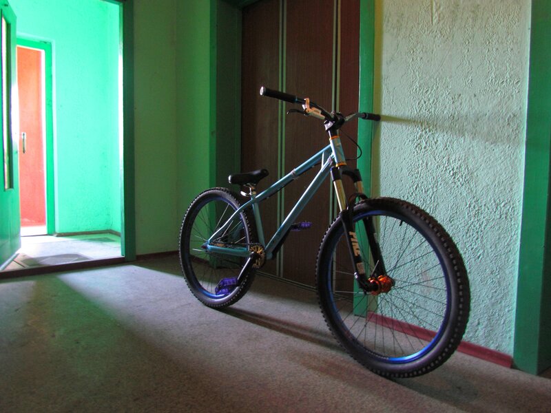 blue mountain bike in hallway