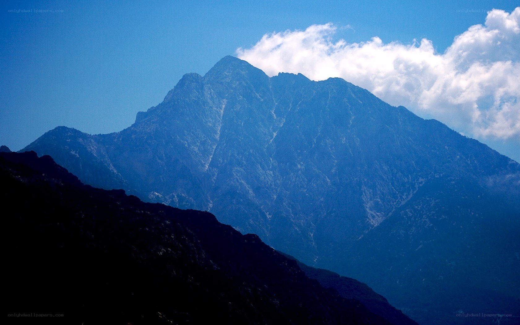Blue mountain peak with clouds