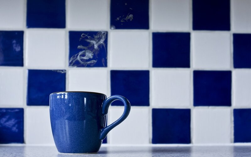 Blue mug on tiled counter