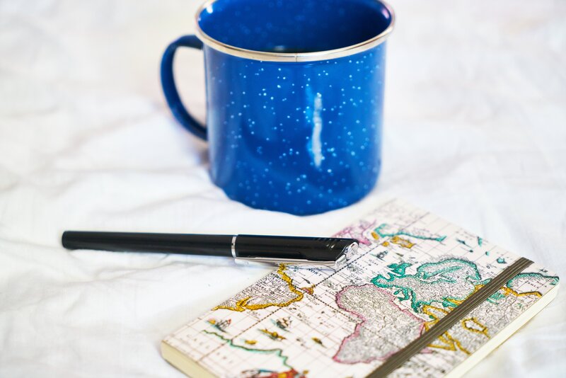 blue mug with map notebook