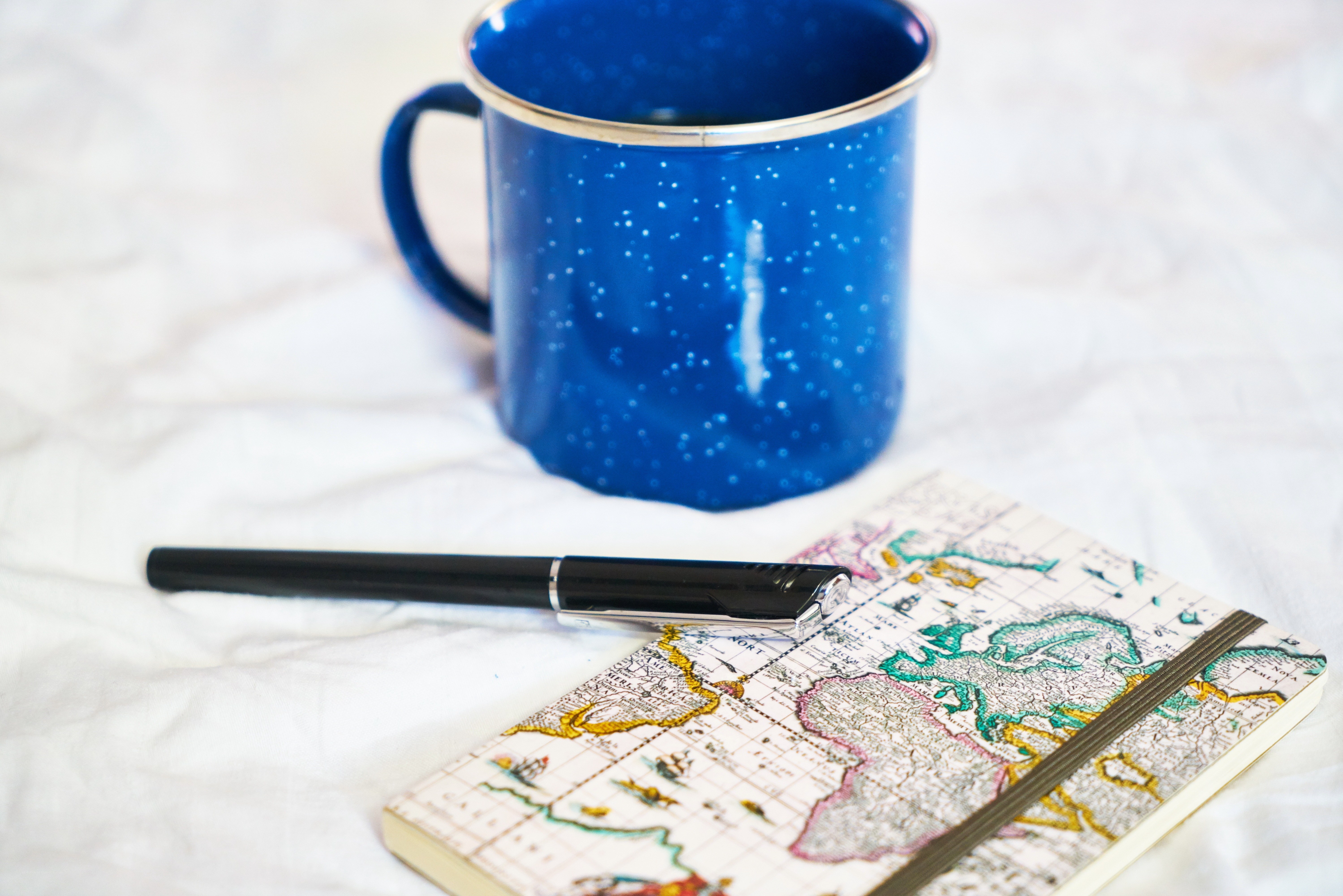 blue mug with map notebook