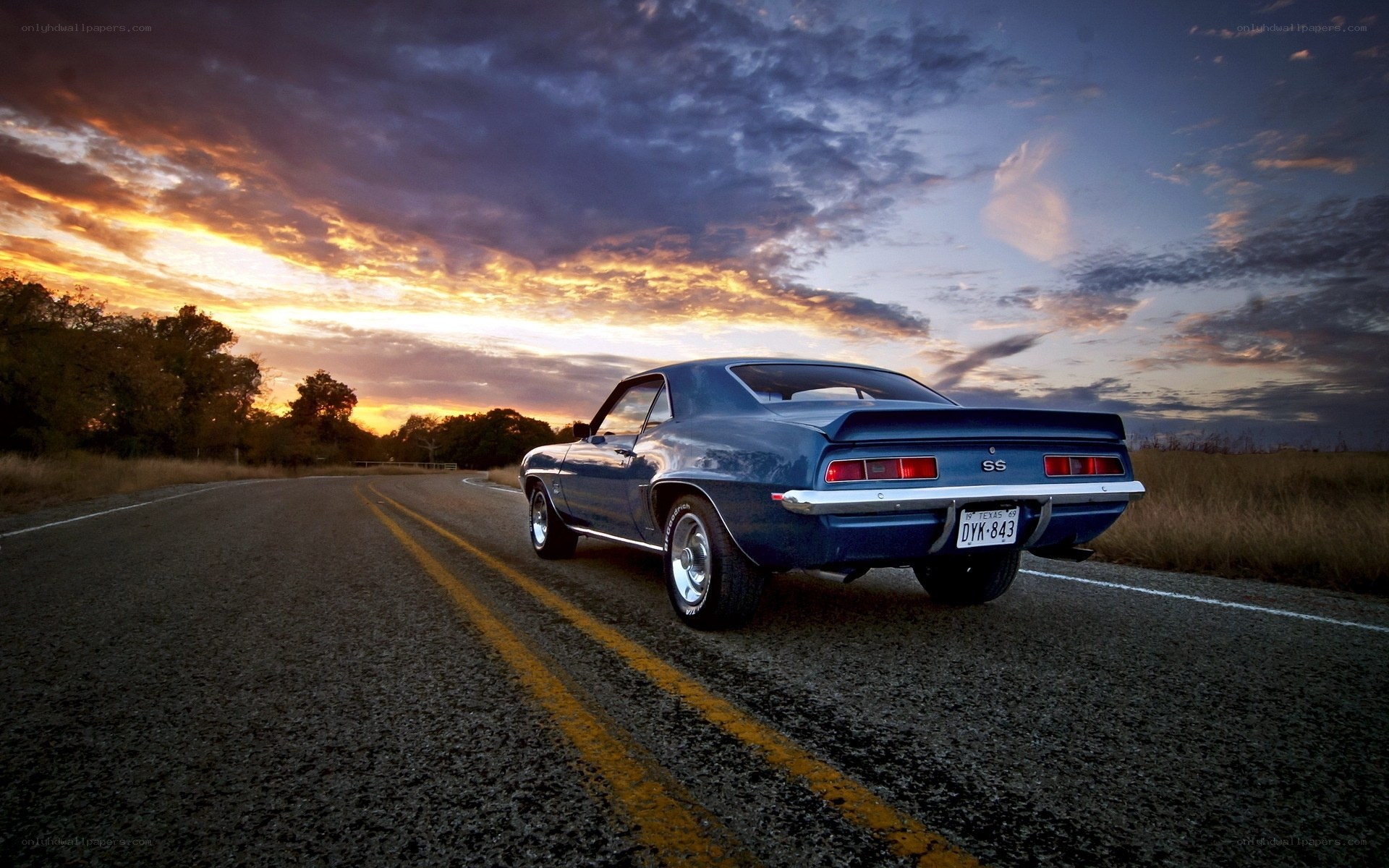 Blue muscle car at sunset