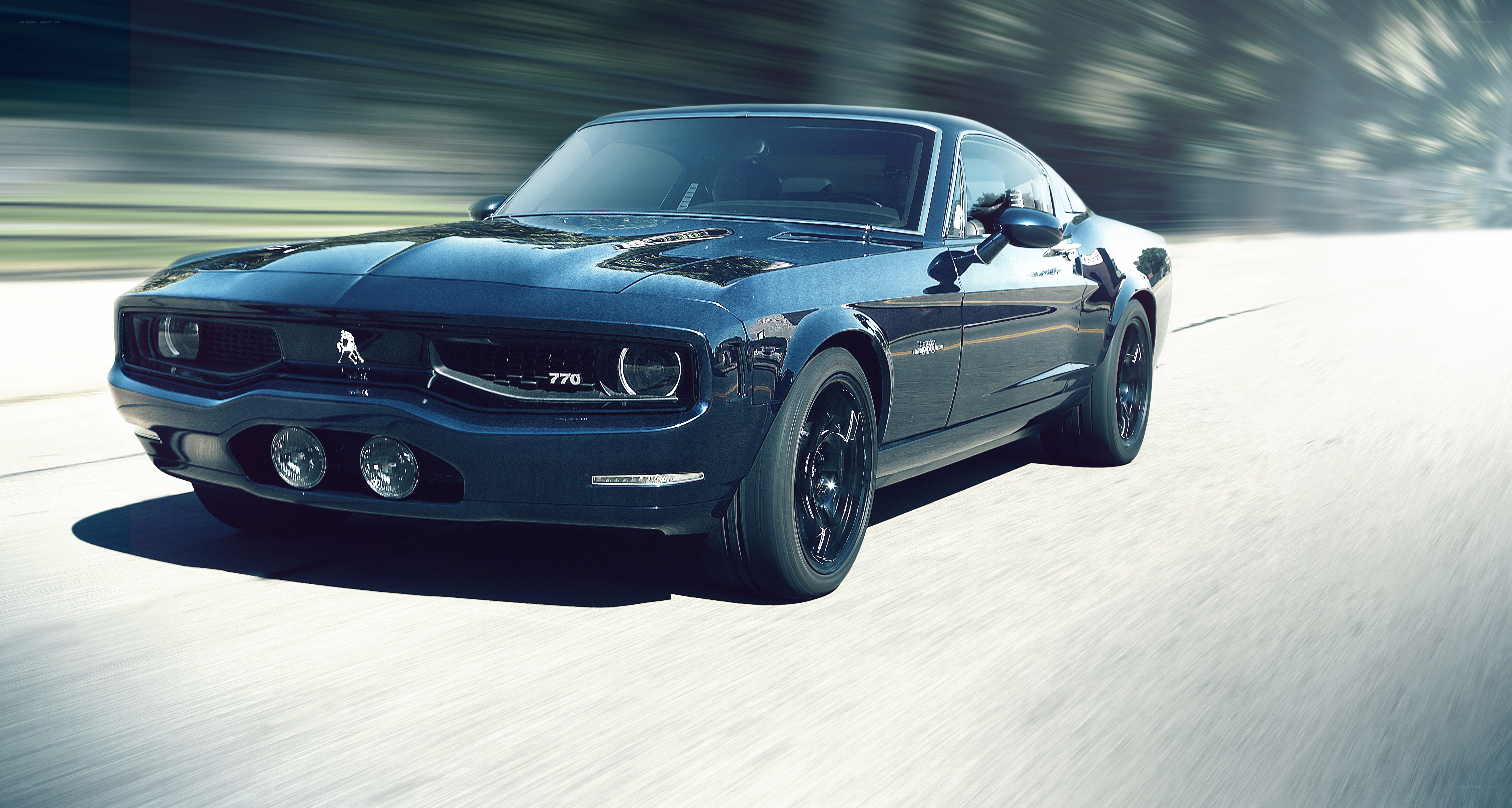 blue muscle car in motion