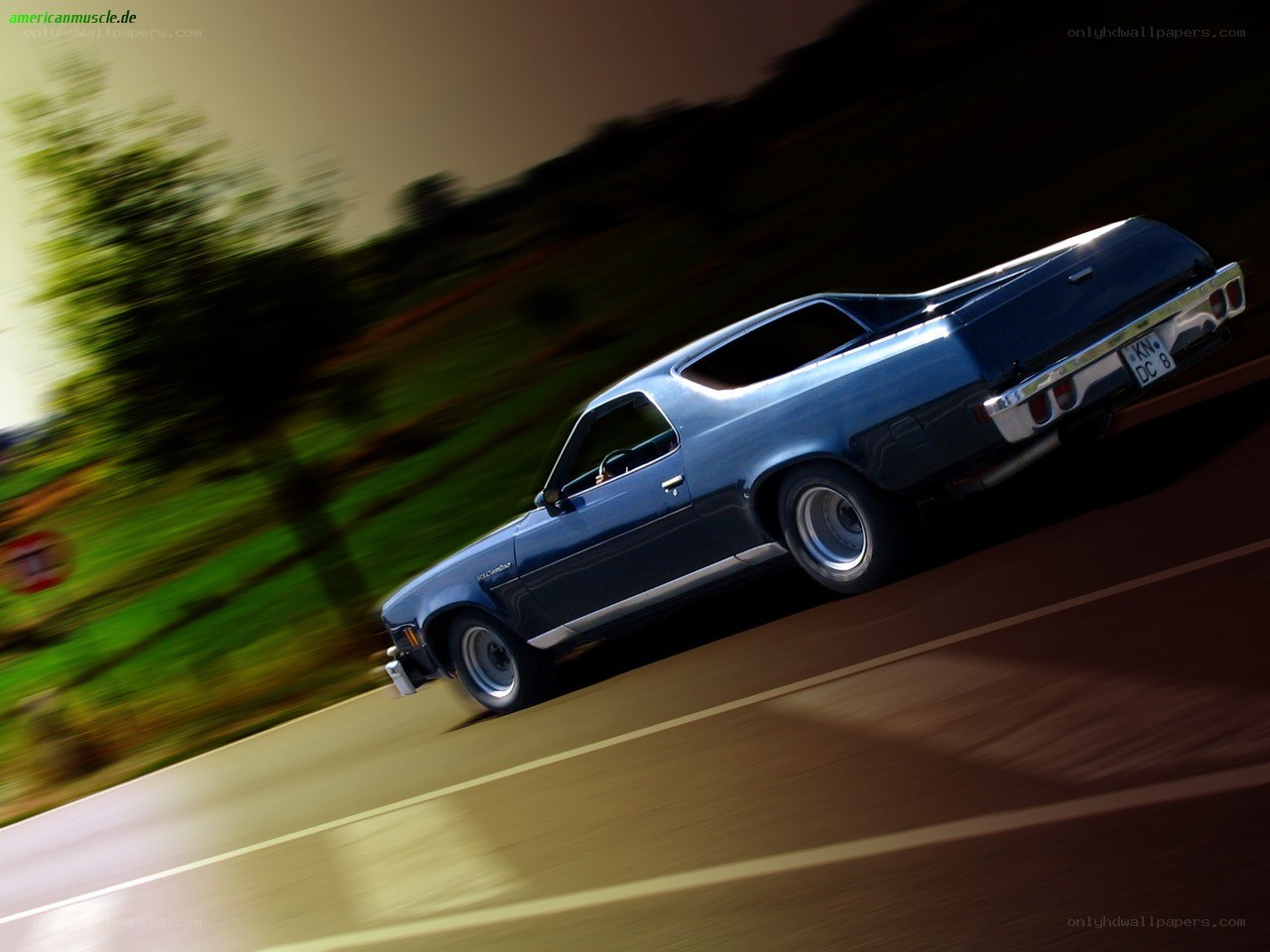 blue muscle car in motion