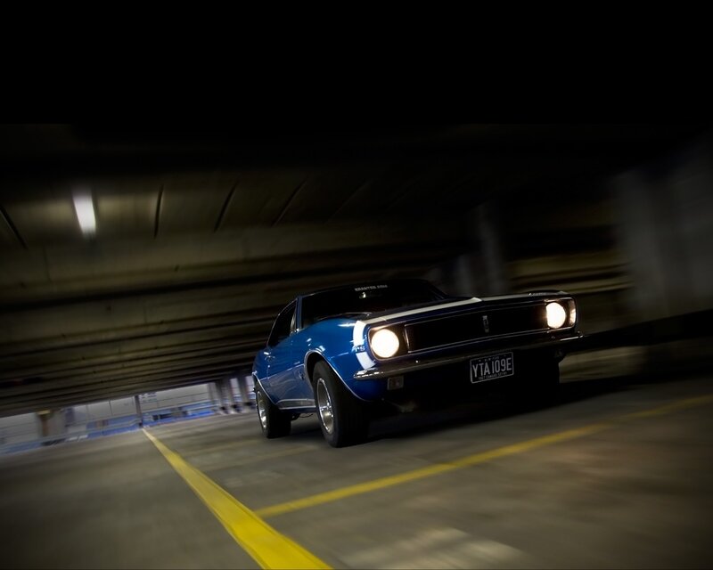 Blue muscle car in parking garage