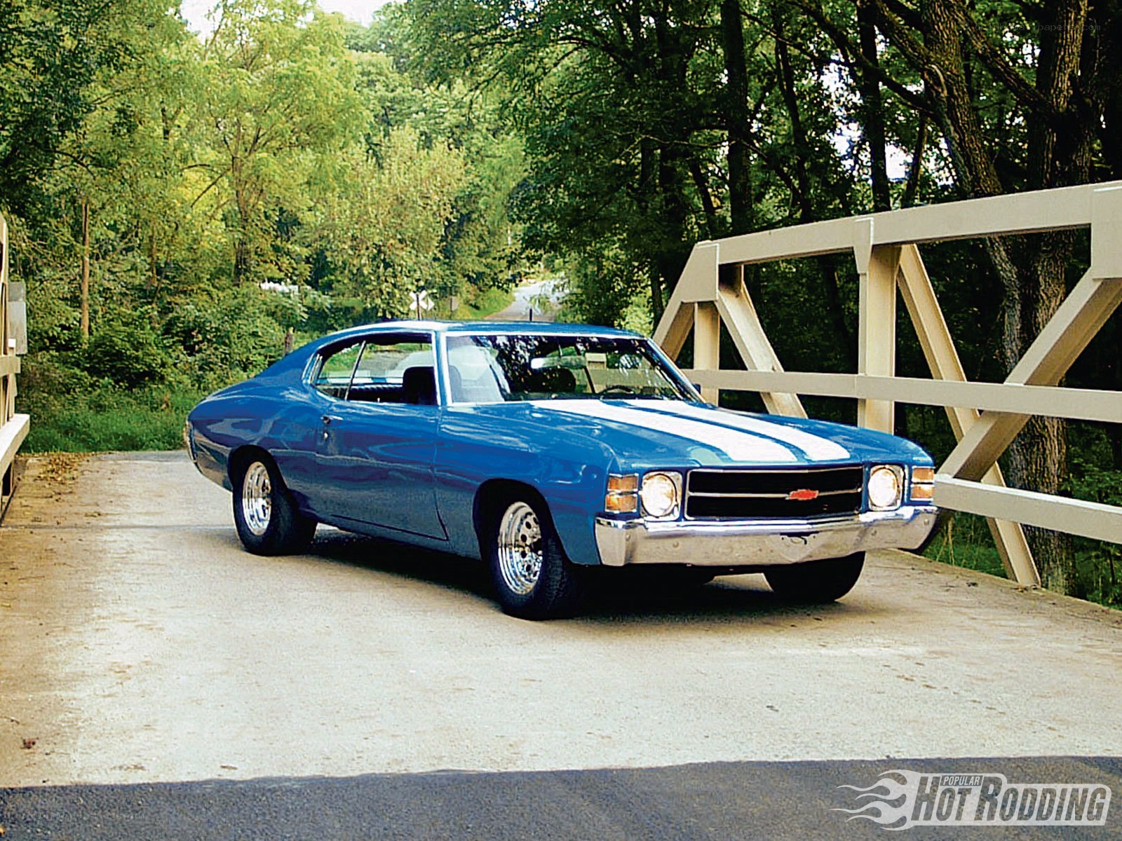 Blue muscle car on a bridge