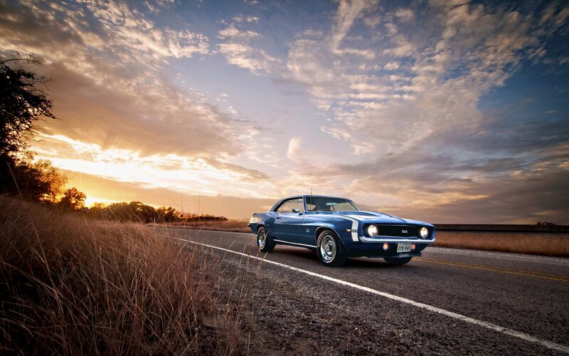 Blue muscle car on a country road