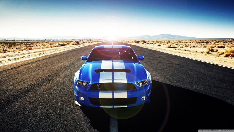 blue muscle car on desert road