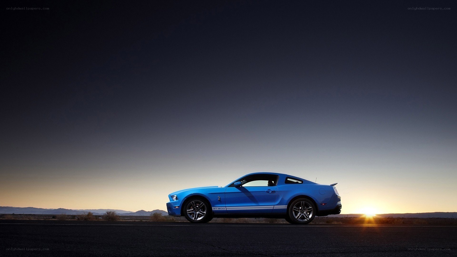 blue mustang at sunset