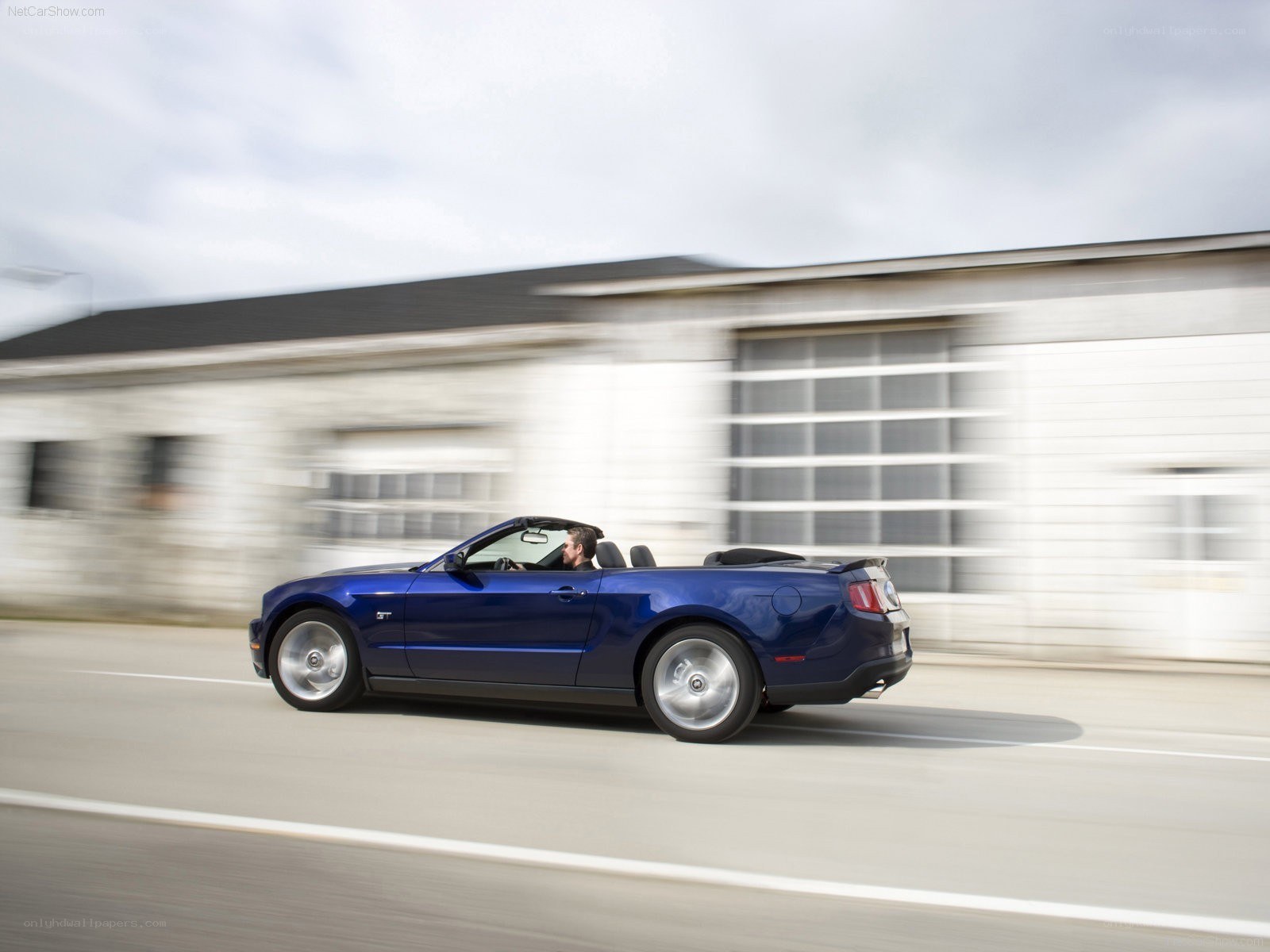blue mustang convertible in motion