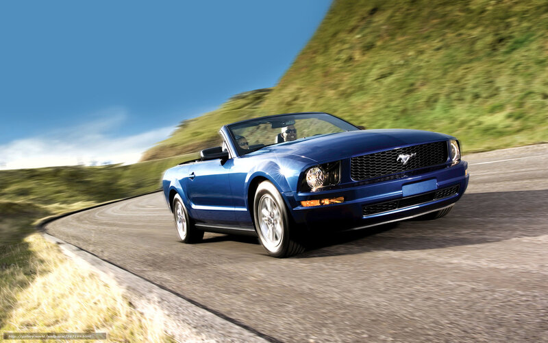 Blue Mustang convertible on a winding road